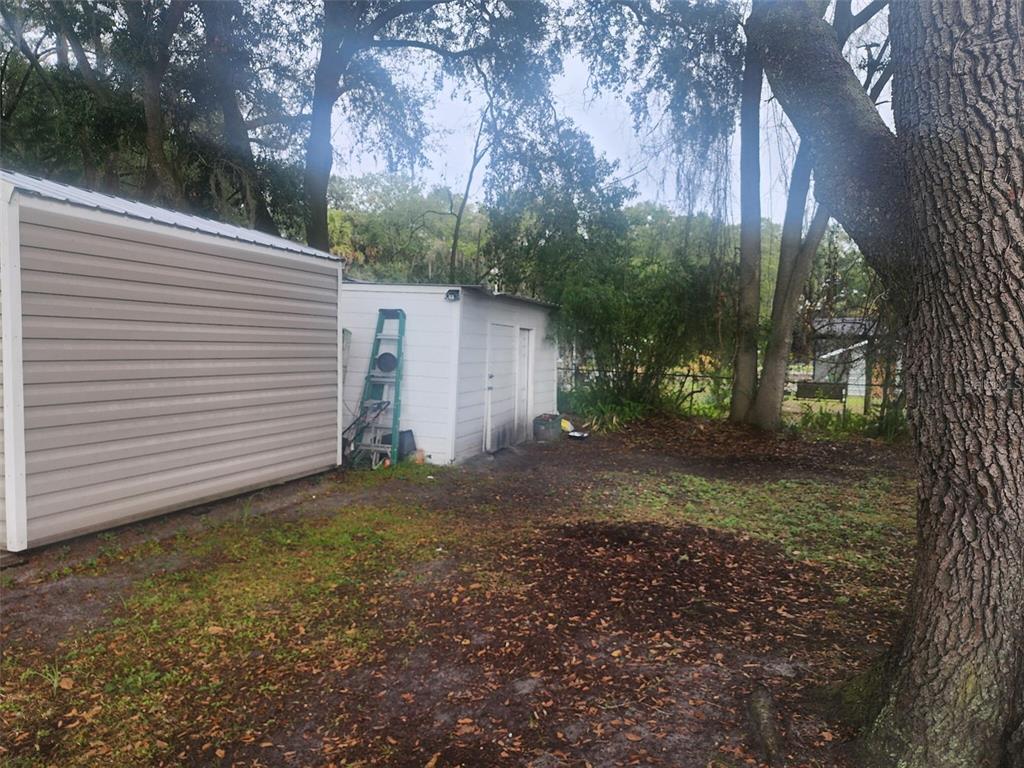 13712 Coman Road Jacksonville, FL 32218 - Photo 9 of 16 a view of a house with a yard and tree