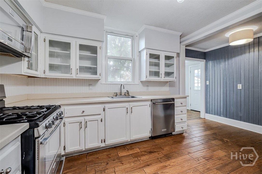 514 Maupas Avenue Savannah, GA 31401 - Photo 24 of 53 In one wall of the kitchen there is room fora small bistro table and chairs or perhaps a nice storage or display cabinet. The flooring is wood.