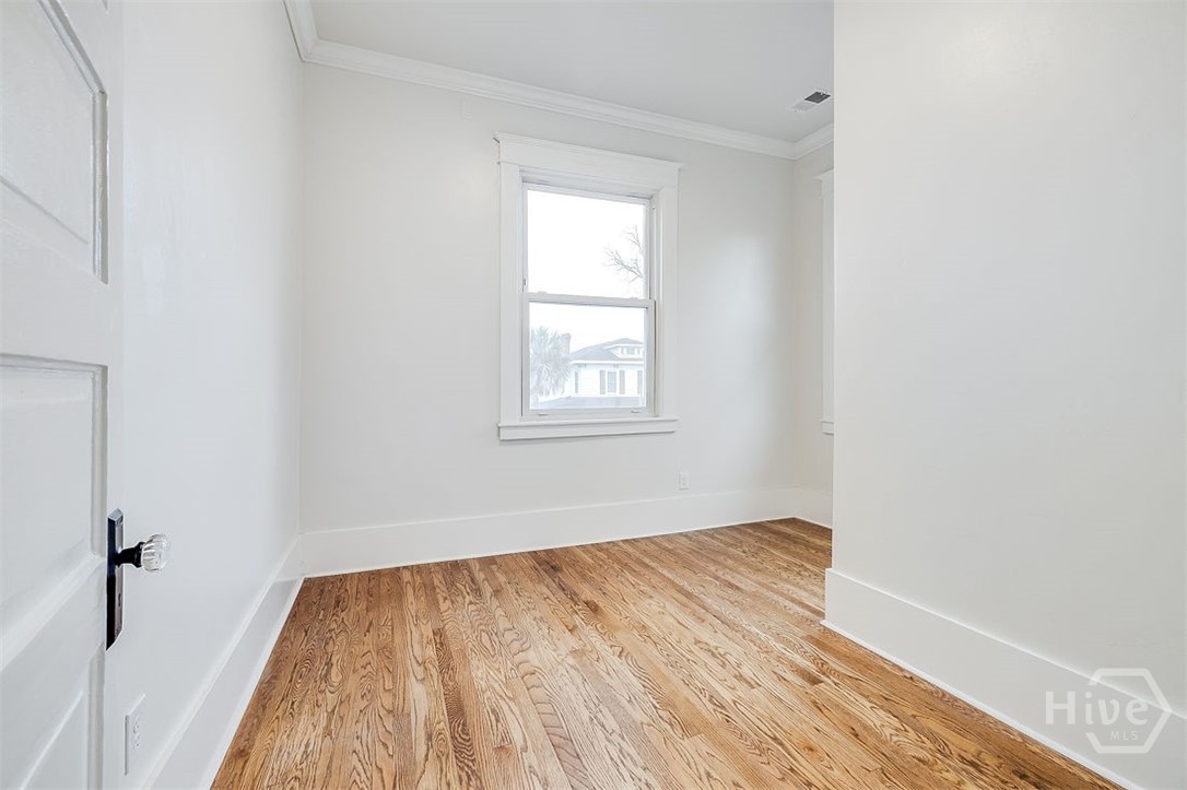 514 Maupas Avenue Savannah, GA 31401 - Photo 42 of 53 The third Bedroom has oak flooring and can also serve as an office space if desired.