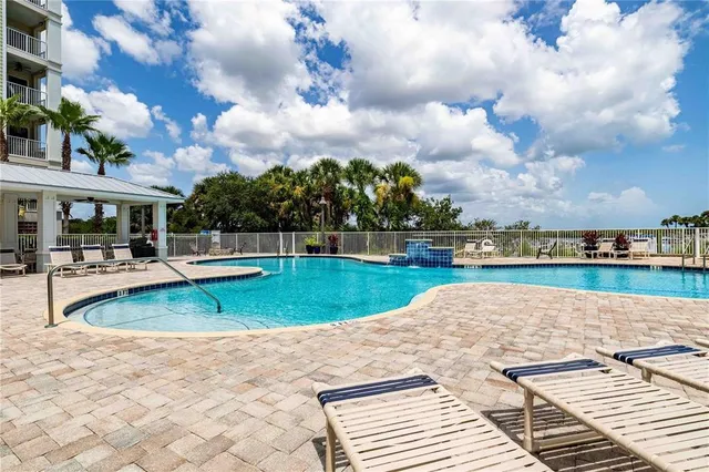 a view of a swimming pool with an outdoor seating