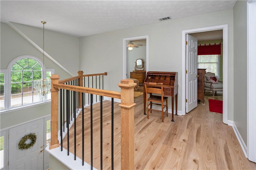 405 Ridgemont Drive Fayetteville, GA 30215 - Photo 17 of 43 a view of a hallway with wooden floor and entryway