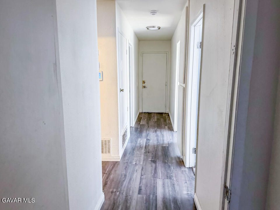 1253 Morven Street Lancaster, CA 93535 - Photo 11 of 18 a view of a hallway with wooden floor