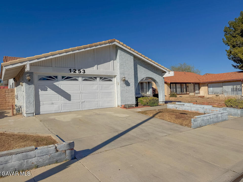 1253 Morven Street Lancaster, CA 93535 - Photo 18 of 18 a front view of a house with garage