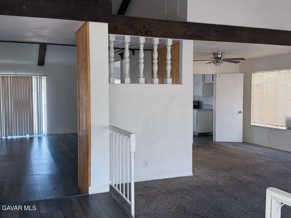 1253 Morven Street Lancaster, CA 93535 - Photo 5 of 18 a view of a hallway with entryway wooden floor and front door