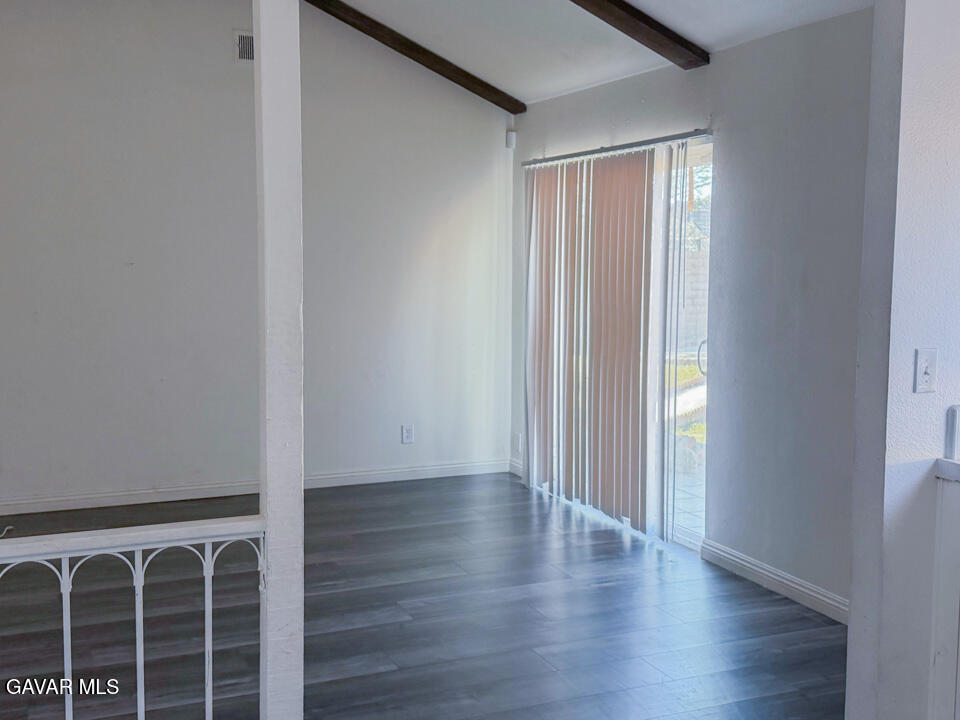 1253 Morven Street Lancaster, CA 93535 - Photo 6 of 18 a view of an empty room with wooden floor and a window