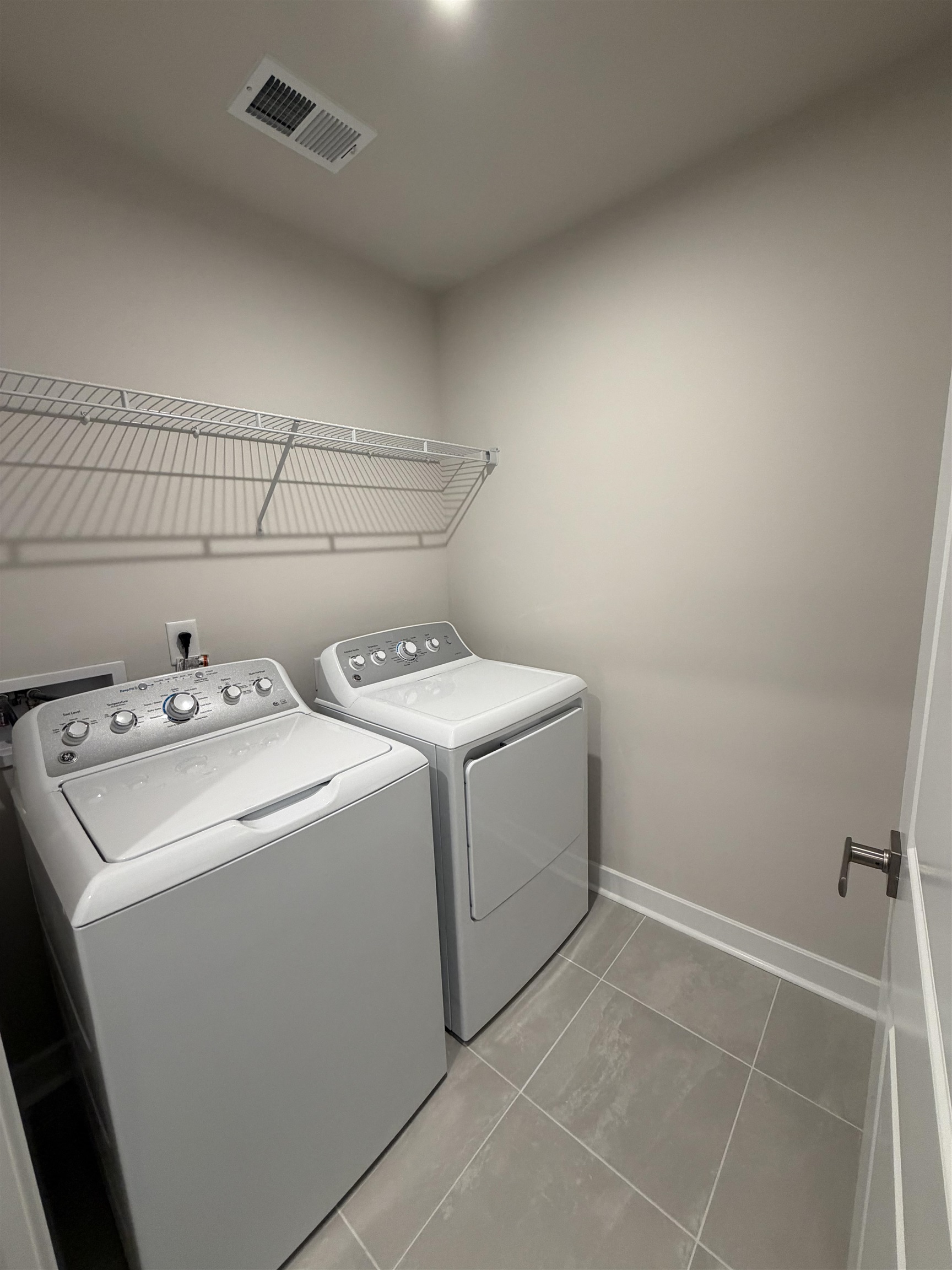 1311 Pleasant View Drive, Unit F North Myrtle Beach, SC 29582 - Photo 11 of 13 Washroom with washer and dryer and light tile patterned flooring