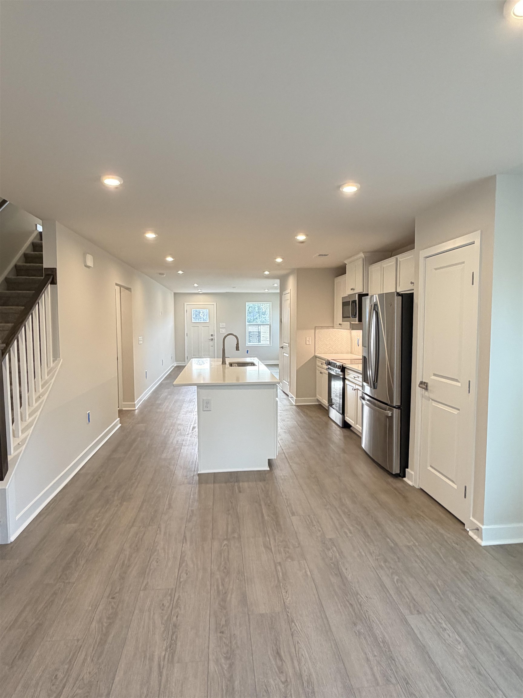 1311 Pleasant View Drive, Unit F North Myrtle Beach, SC 29582 - Photo 3 of 13 Kitchen featuring recessed lighting, a kitchen island with sink, white cabinets, appliances with stainless steel finishes, and light wood-type flooring