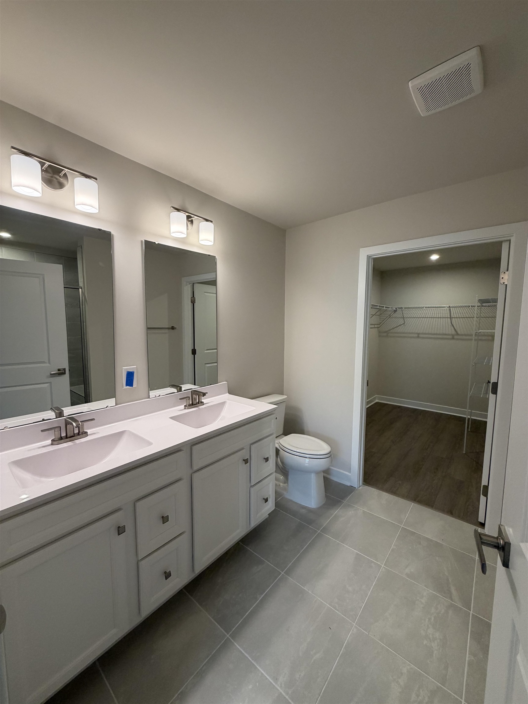 1311 Pleasant View Drive, Unit F North Myrtle Beach, SC 29582 - Photo 5 of 13 Bathroom featuring a spacious closet, double vanity, light tile patterned floors, and a shower
