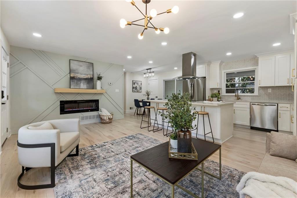 1690 Carter Road Decatur, GA 30032 - Photo 1 of 49 a living room with furniture a table and kitchen view