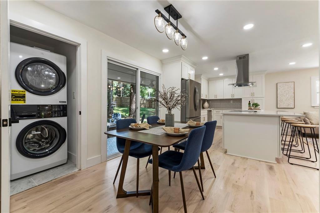 1690 Carter Road Decatur, GA 30032 - Photo 15 of 49 a kitchen with a table chairs a stove and a clock