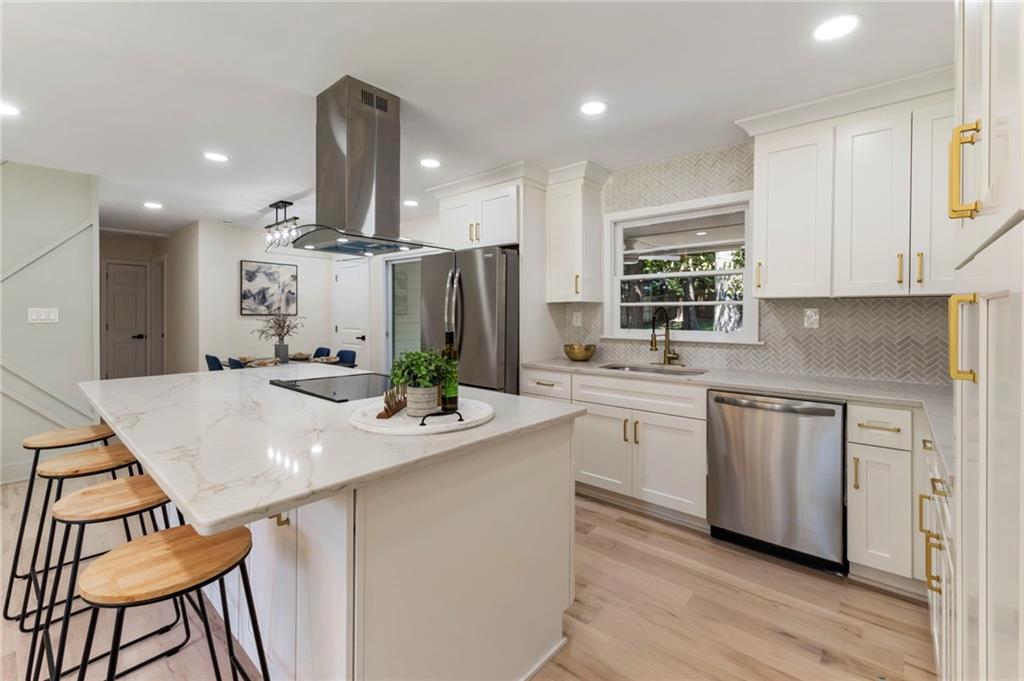 1690 Carter Road Decatur, GA 30032 - Photo 19 of 49 a kitchen with stainless steel appliances kitchen island granite countertop a sink and cabinets