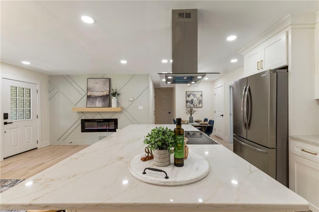1690 Carter Road Decatur, GA 30032 - Photo 20 of 49 a kitchen with stainless steel appliances kitchen island granite countertop a refrigerator and a sink
