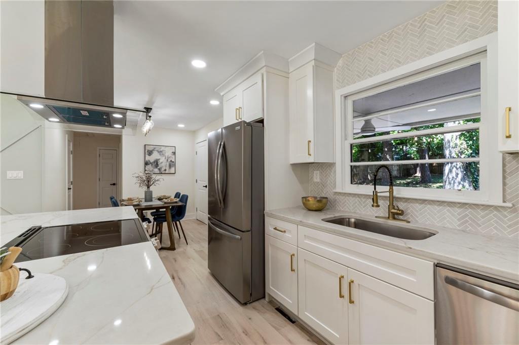 1690 Carter Road Decatur, GA 30032 - Photo 21 of 49 a kitchen with a sink and a refrigerator