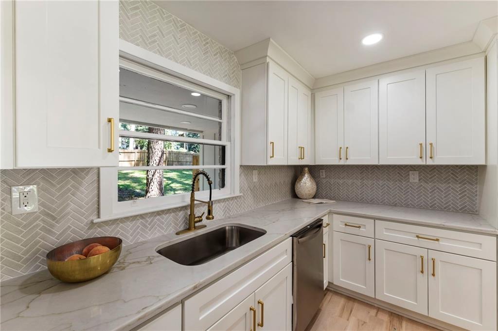 1690 Carter Road Decatur, GA 30032 - Photo 25 of 49 a kitchen with white cabinets and sink
