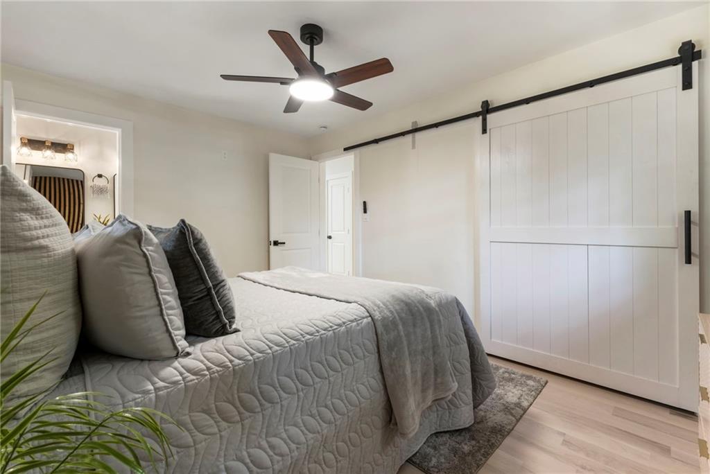 1690 Carter Road Decatur, GA 30032 - Photo 27 of 49 a bedroom with a bed and a ceiling fan