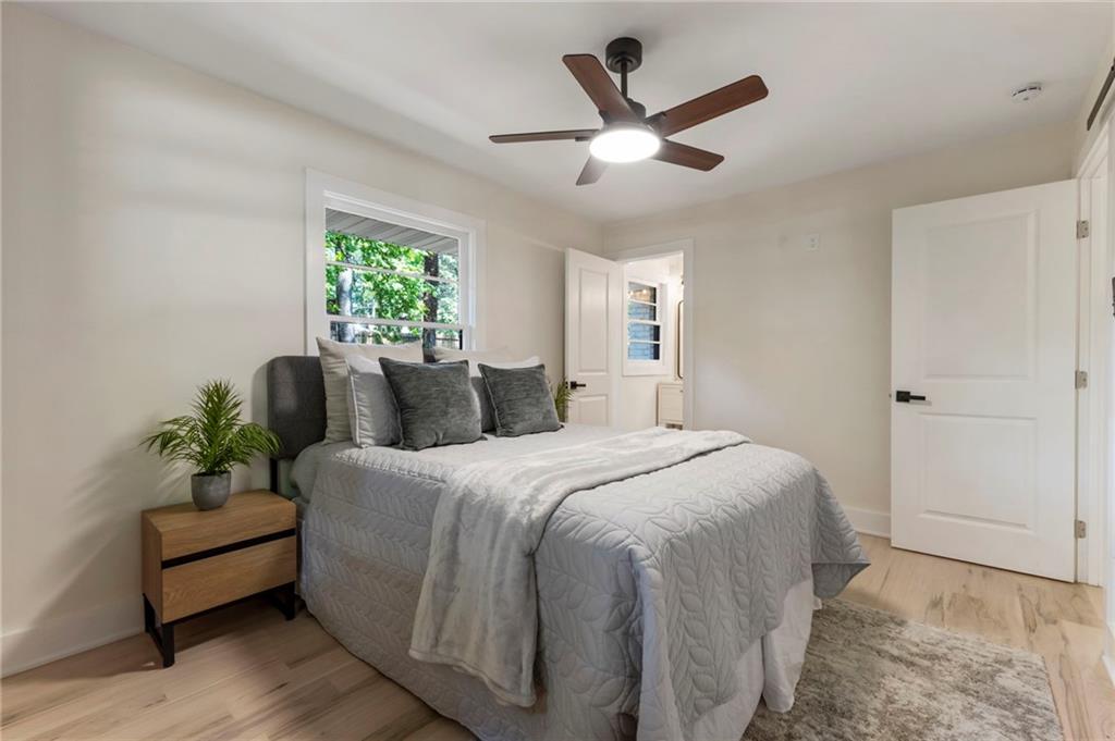 1690 Carter Road Decatur, GA 30032 - Photo 29 of 49 a bed room with a bed and a potted plant