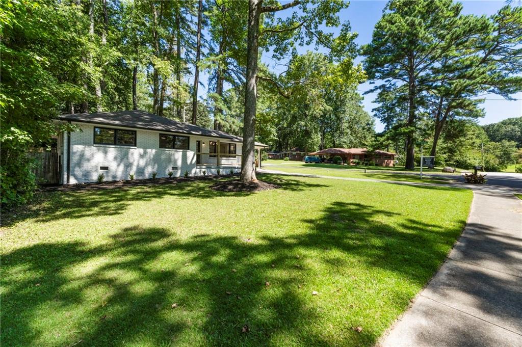 1690 Carter Road Decatur, GA 30032 - Photo 3 of 49 a view of yard with swimming pool and large trees
