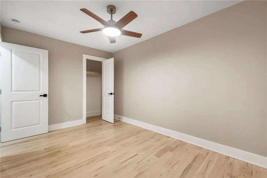 1690 Carter Road Decatur, GA 30032 - Photo 38 of 49 an empty room with wooden floor and ceiling fan