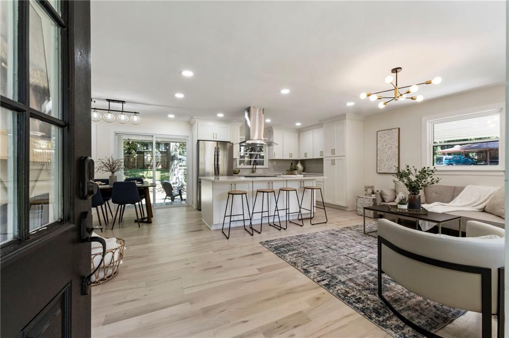 1690 Carter Road Decatur, GA 30032 - Photo 4 of 49 a living room with furniture a wooden floor and a large window