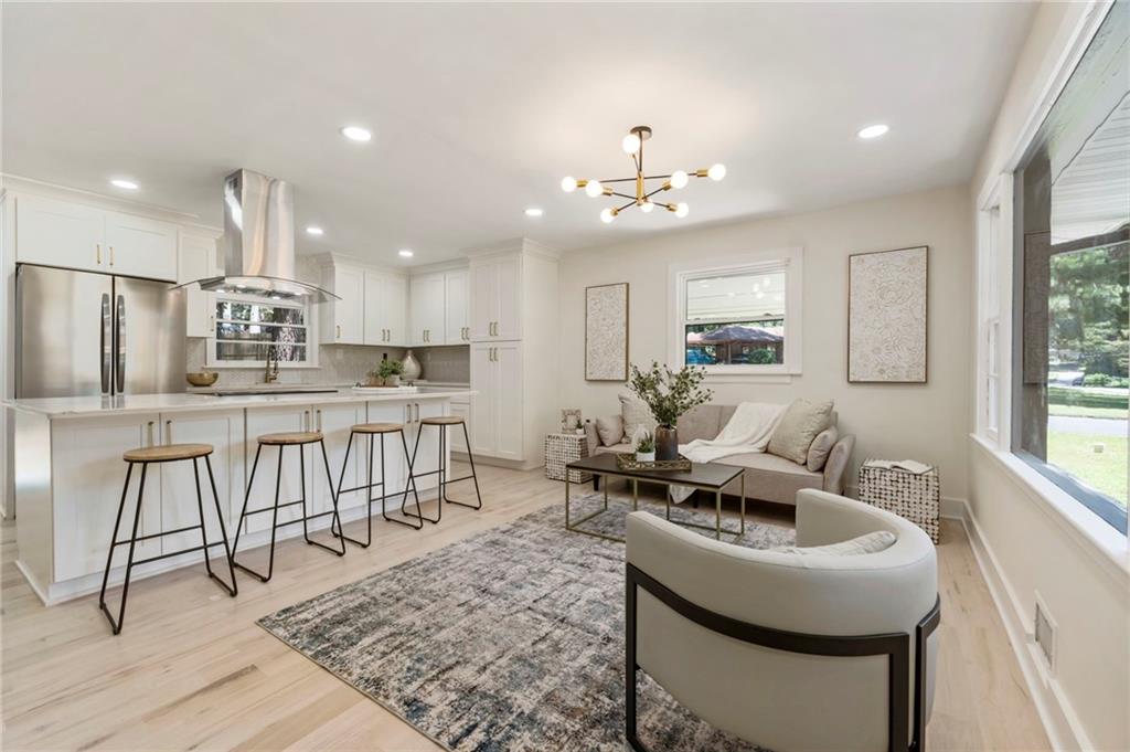 1690 Carter Road Decatur, GA 30032 - Photo 10 of 49 a kitchen with stainless steel appliances kitchen island granite countertop a sink a stove a dining table and chairs