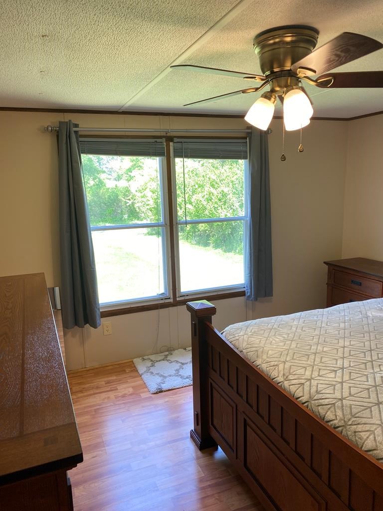 313 Lonesome Pine Road Bybee, TN 37713 - Photo 37 of 48 a bedroom with a bed and a chandelier