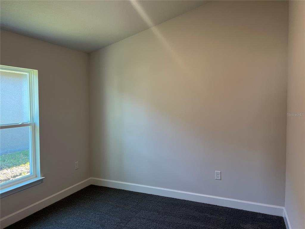 13322 Ogden Glade Road Dade City, FL 33525 - Photo 12 of 24 an empty room with a window