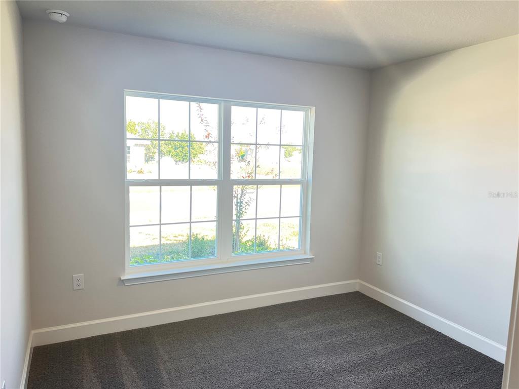 13322 Ogden Glade Road Dade City, FL 33525 - Photo 14 of 24 an empty room with a window