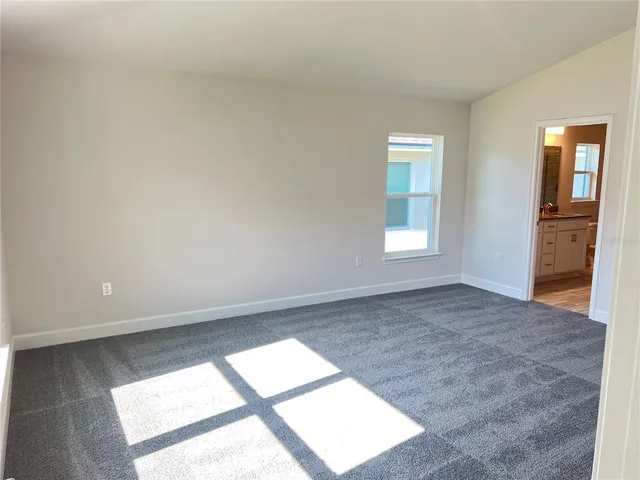 a kitchen with granite countertop a sink a stove and cabinets