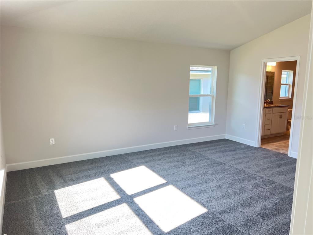 13322 Ogden Glade Road Dade City, FL 33525 - Photo 6 of 24 an empty room with windows