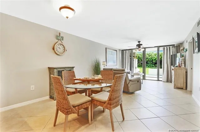 a kitchen with granite countertop stainless steel appliances white cabinets granite counter tops and a wooden floors