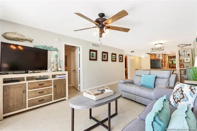 a bedroom with a bed a wall painting and a book shelf
