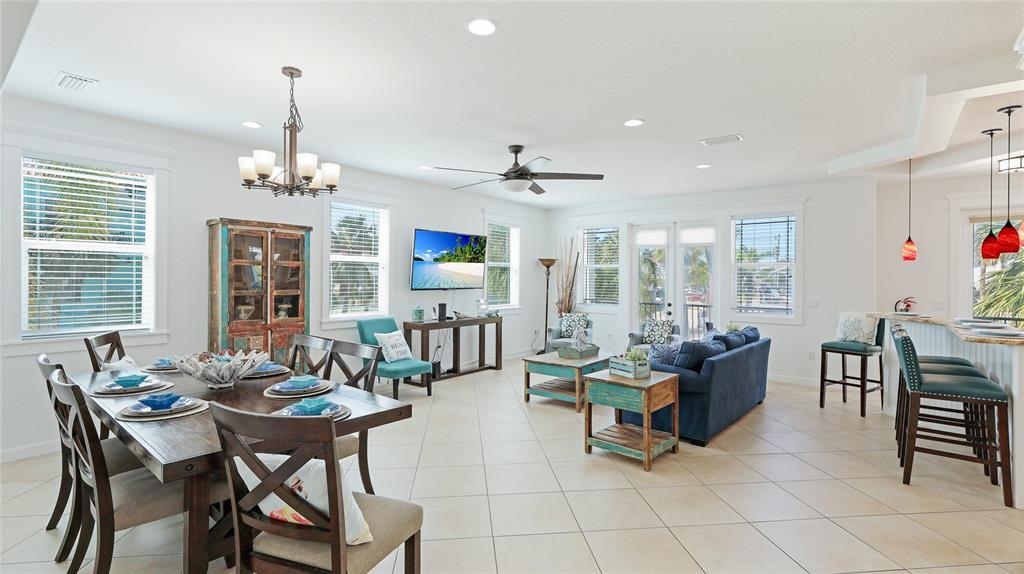 4101 4th Avenue Holmes Beach, FL 34217 - Photo 12 of 60 a living room with furniture and a chandelier