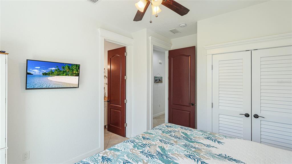 4101 4th Avenue Holmes Beach, FL 34217 - Photo 19 of 60 a bedroom with a bed and a chandelier