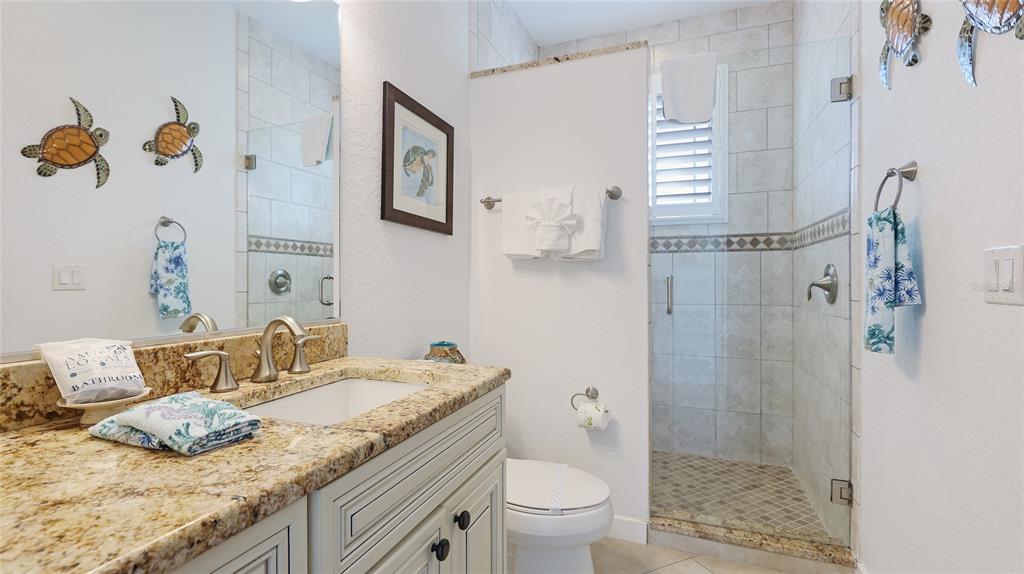 4101 4th Avenue Holmes Beach, FL 34217 - Photo 21 of 60 a bathroom with a granite countertop sink and a mirror