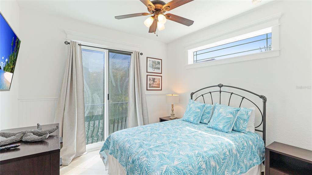 4101 4th Avenue Holmes Beach, FL 34217 - Photo 22 of 60 a bedroom with a bed and a chandelier