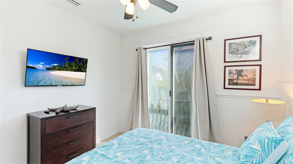 4101 4th Avenue Holmes Beach, FL 34217 - Photo 23 of 60 a bedroom with a bed and a flat screen tv