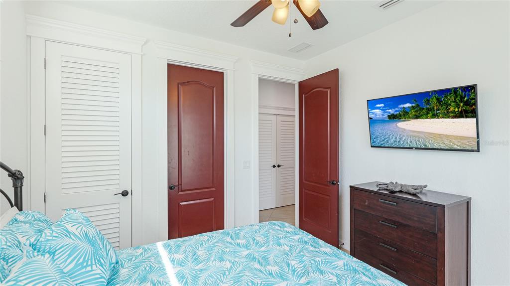 4101 4th Avenue Holmes Beach, FL 34217 - Photo 24 of 60 a bedroom with a bed and a flat screen tv