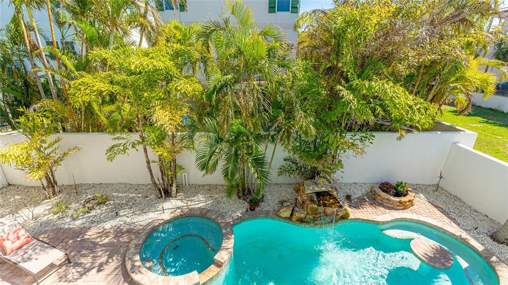 4101 4th Avenue Holmes Beach, FL 34217 - Photo 25 of 60 a backyard of a house with table and chairs