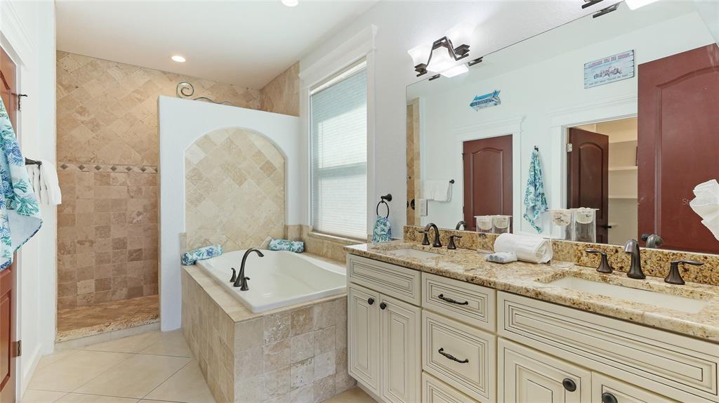 4101 4th Avenue Holmes Beach, FL 34217 - Photo 34 of 60 a bathroom with double vanity sinks a vanity a mirror and a shower