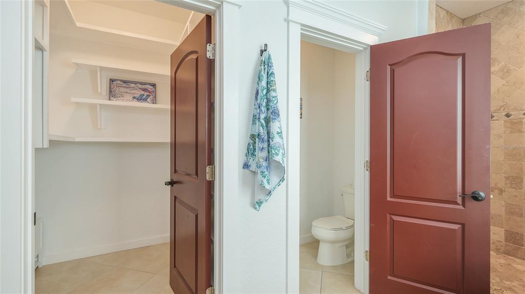 4101 4th Avenue Holmes Beach, FL 34217 - Photo 35 of 60 a bathroom with a granite countertop toilet a sink and a mirror
