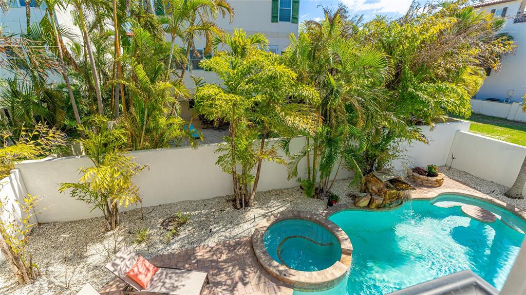 4101 4th Avenue Holmes Beach, FL 34217 - Photo 43 of 60 a backyard of a house with table and chairs