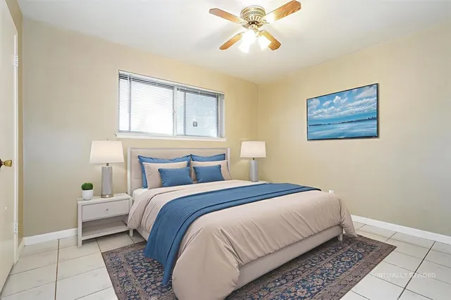 a bedroom with a bed and painting on the wall