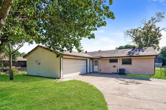 a front view of house with a garden