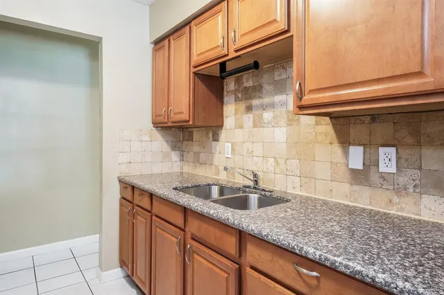 a kitchen with stainless steel appliances granite countertop a sink and a white cabinets