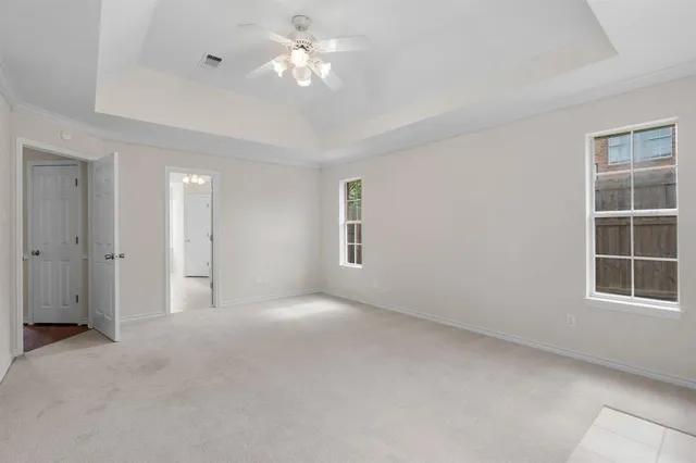 a bathroom with a granite countertop sink a toilet a large mirror and bathtub