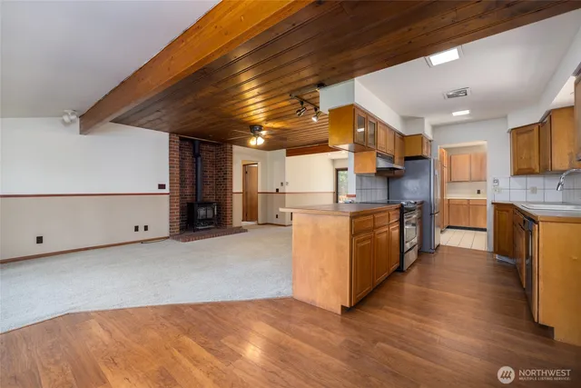 a hallway with a large mirror and wooden floor