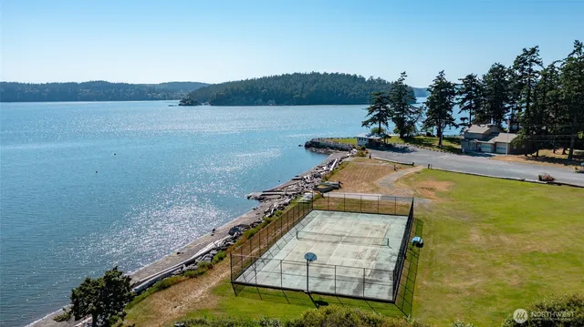 a view of a swimming pool with a patio and a yard