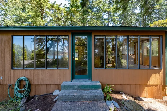 a side view of a house with a porch
