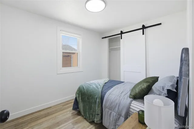 a bed room with a bed and a window