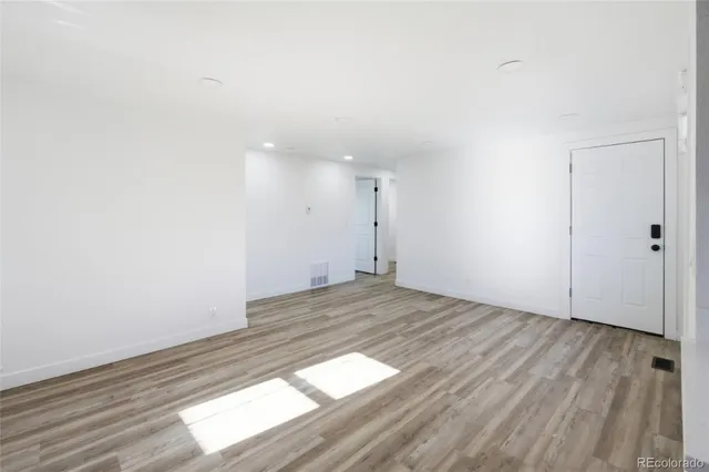 a view of an empty room and wooden floor